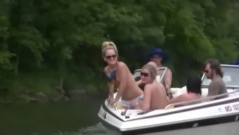 Nasty amateur girls sitting in a boat flash their boobs