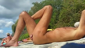 Two old lustful gay people have a rest on a nudist beach.